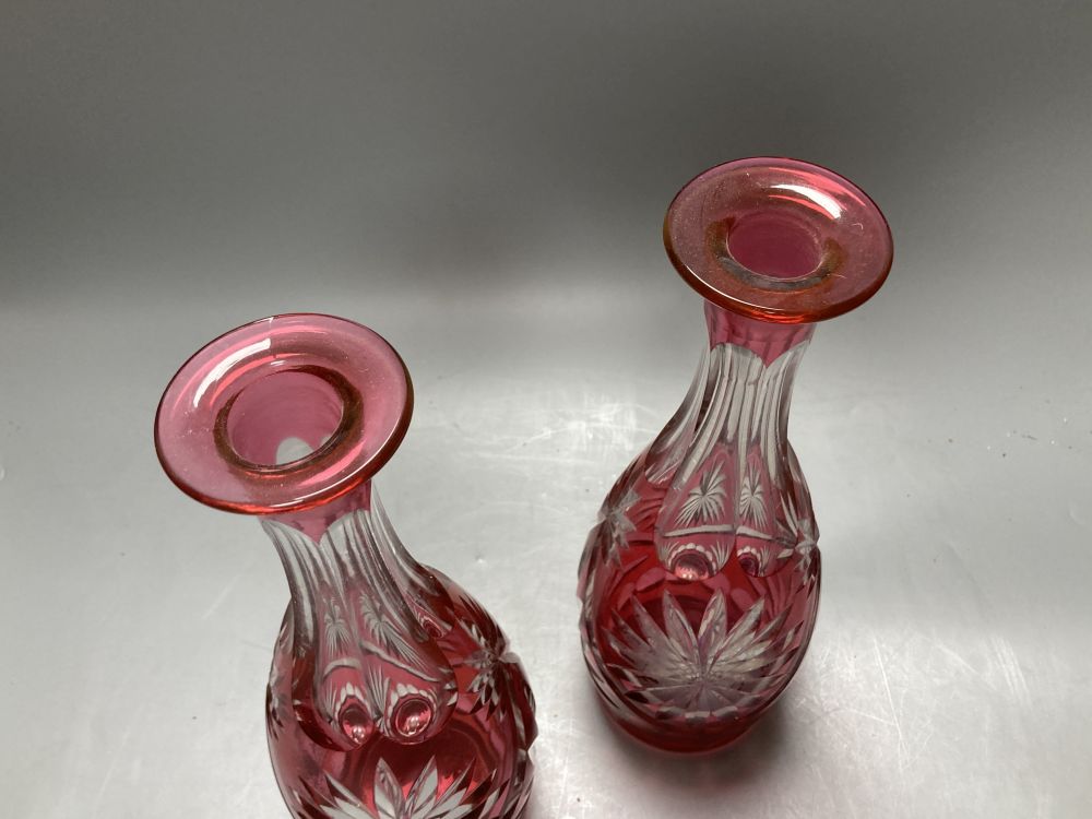 A pair of flash cut cranberry glass decanters and stoppers, height 39.5cm